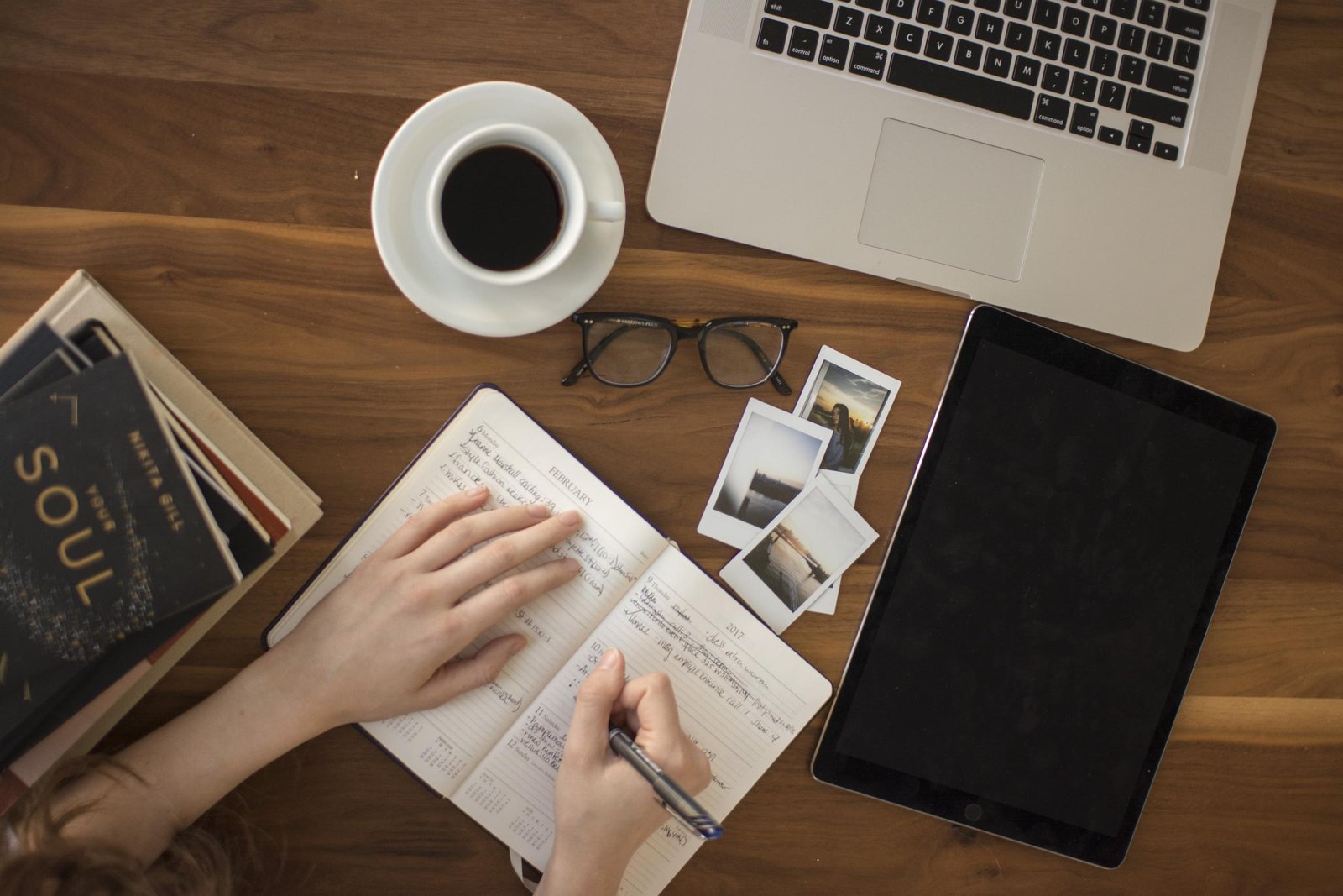 A journal and coffee on a table, representing reflection and questions about therapy.